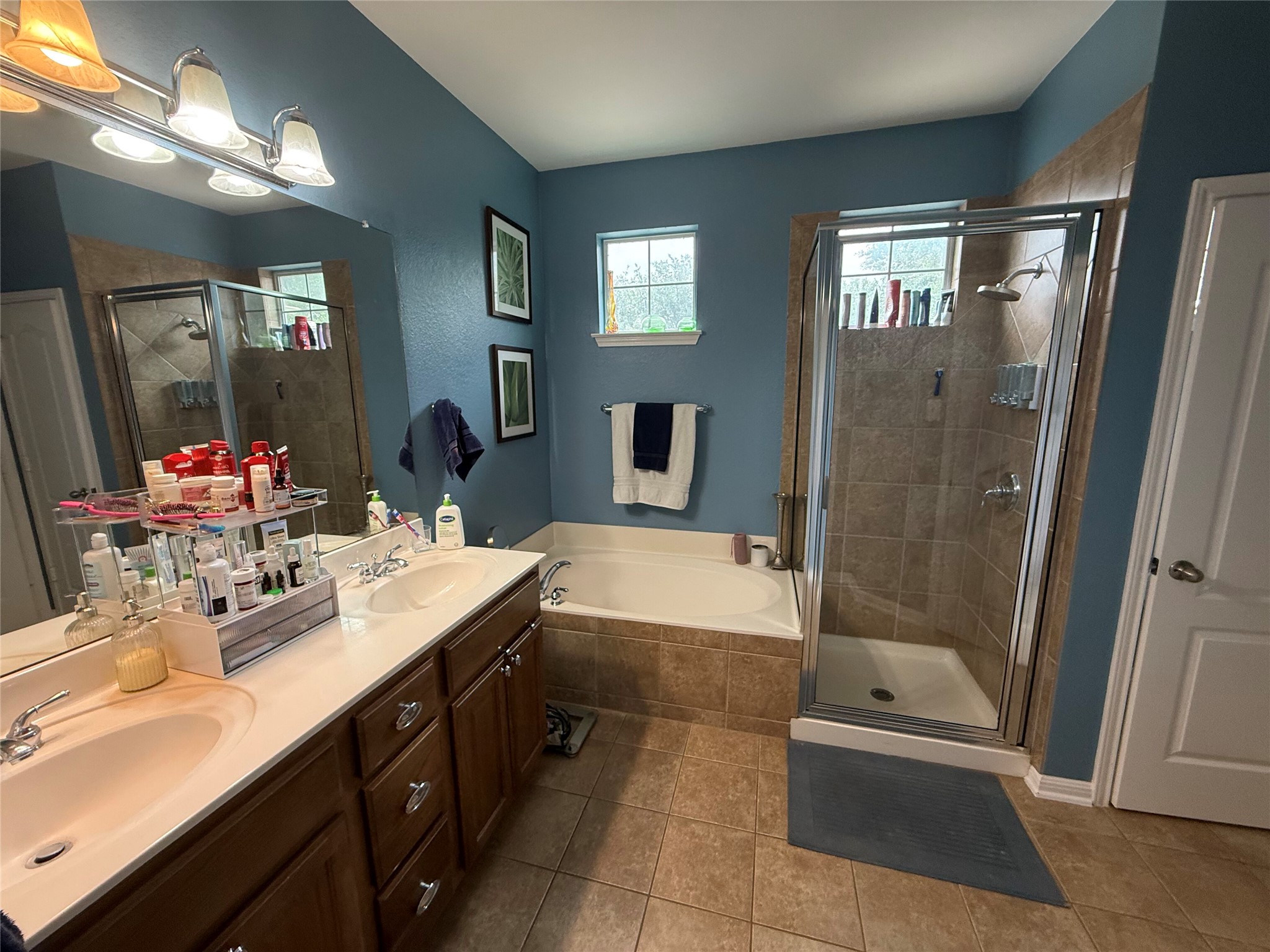 11000 Anderson Mill Road, Unit 93 Austin, TX 78750 - Photo 11 of 27 Relax in this tranquil primary bathroom, offering both a soaking tub and a separate glass-enclosed shower.