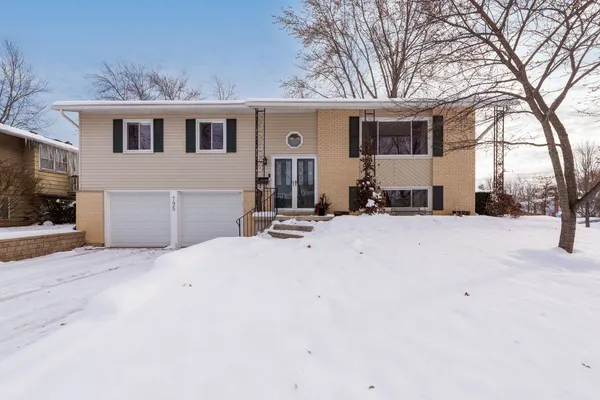 a view of a house with snow on the road