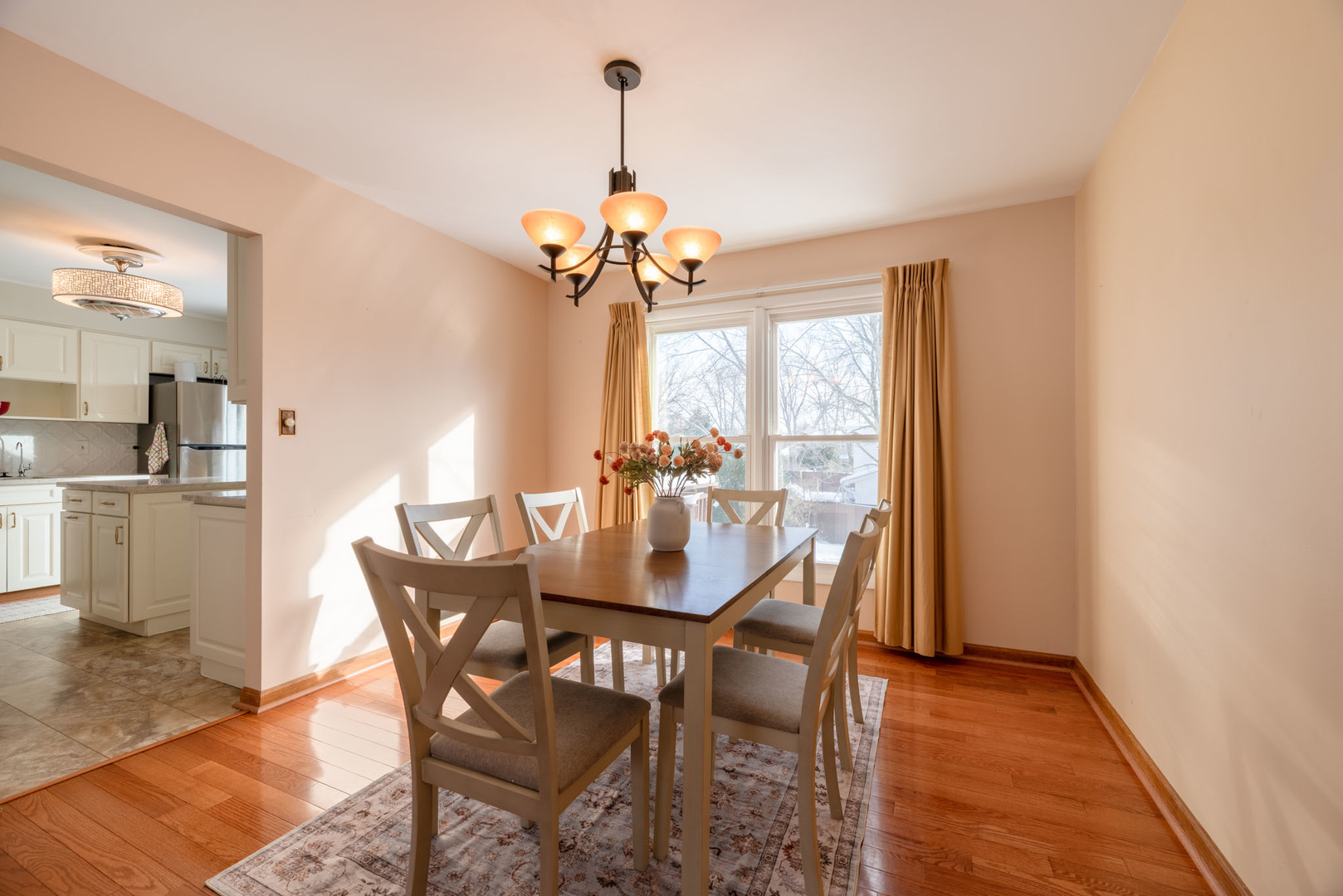 795 Plymouth Road Hoffman Estates, IL 60192 - Photo 7 of 26 a dining room with furniture a chandelier and wooden floor