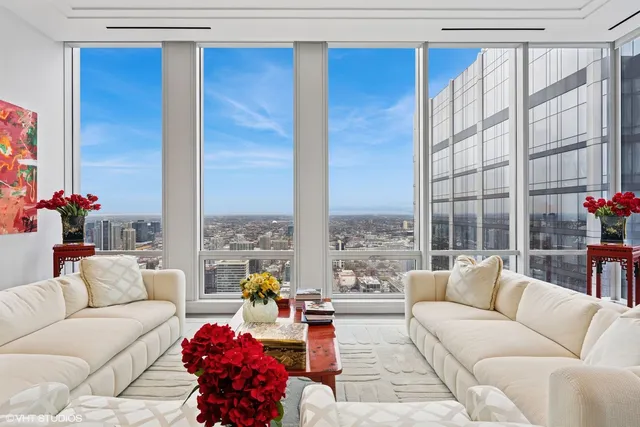 a living room with furniture large window and flat screen tv