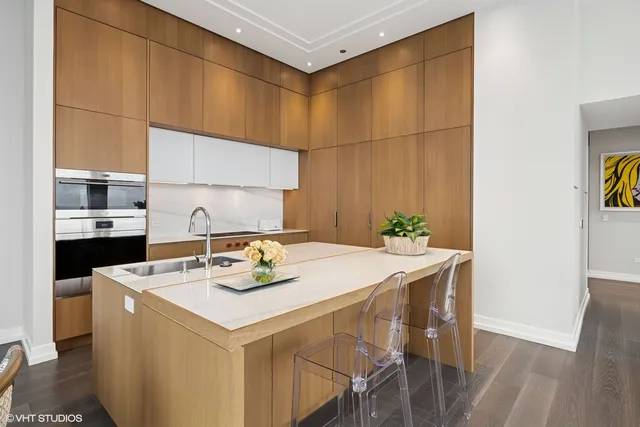 a kitchen with stainless steel appliances kitchen island granite countertop a sink and cabinets