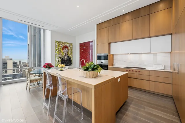 a living room with furniture and kitchen view