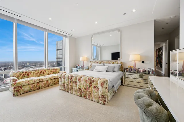 a bedroom with a bed and large window