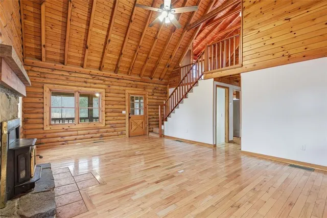 a view of a room with stairs and a wooden floor