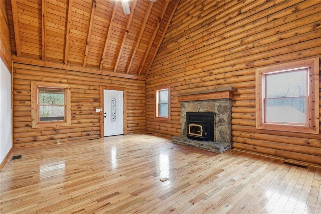 61 Bear Ridge Road Cleveland, GA 30528 - Photo 12 of 71 a view of an empty room with wooden floor fireplace and a window