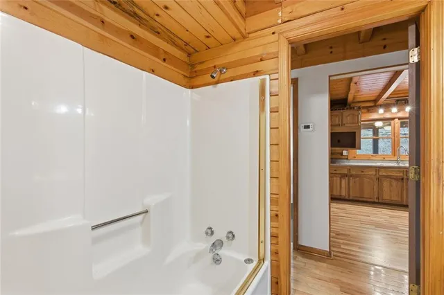 a view of hallway with wooden floor and stairs