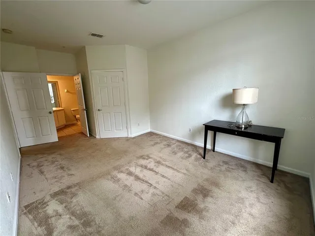 a bedroom with a bed and a mirror