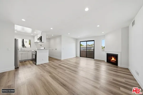 a view of kitchen and hall with wooden floor