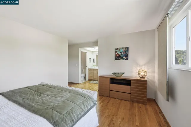 a bedroom with a large bed and a large mirror