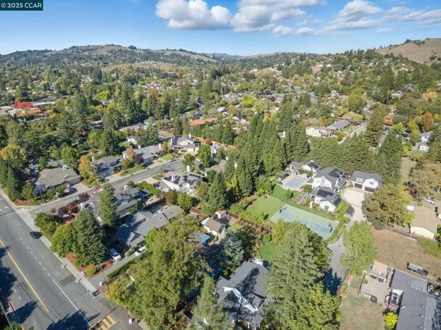 an aerial view of a house with a yard