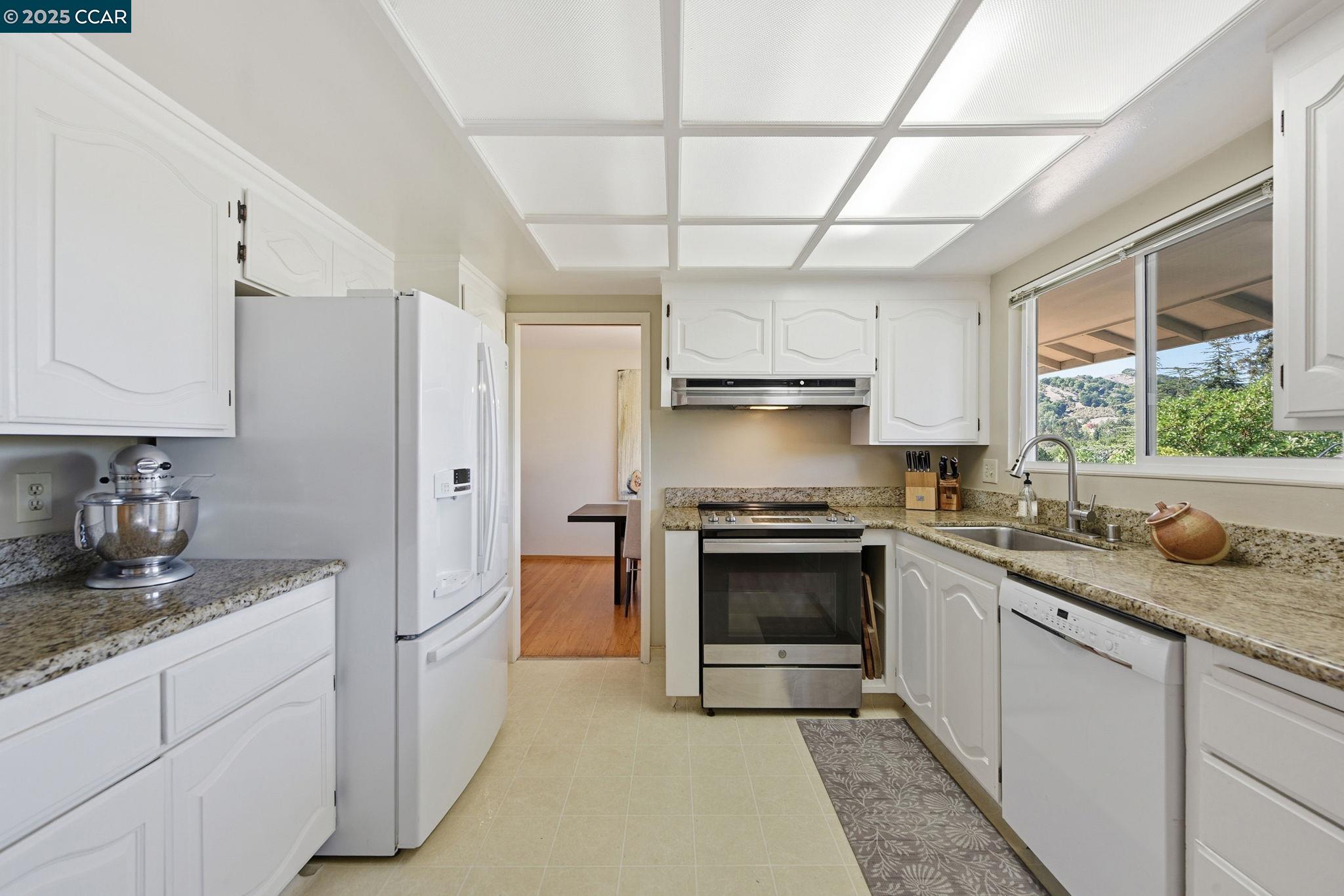 92 Gaywood Place Moraga, CA 94556 - Photo 8 of 52 a kitchen with stainless steel appliances granite countertop a sink a stove and a refrigerator