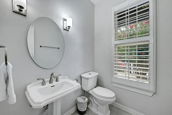 a bathroom with a toilet a sink and a mirror