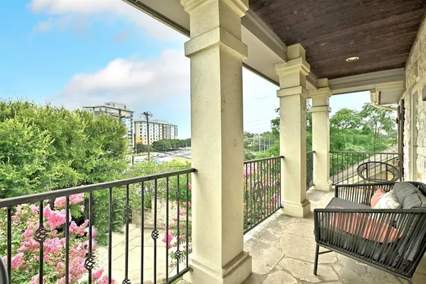 a view of a balcony with furniture