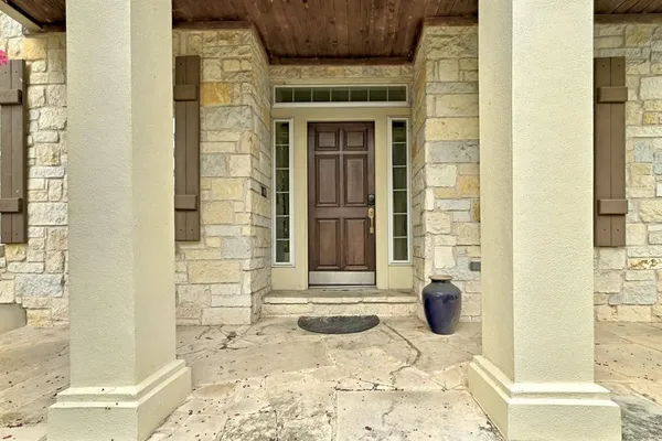 a front view of a house with a potted plant
