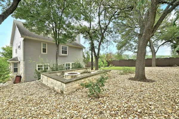 a view of a backyard with a tree