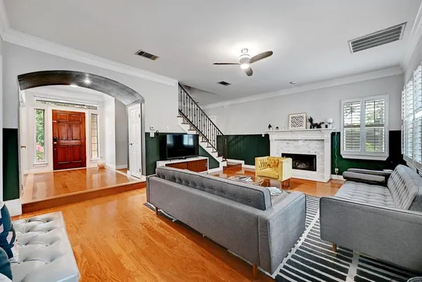 a living room with furniture a fireplace and a flat screen tv
