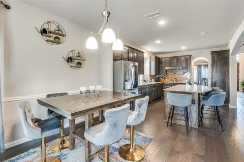 a kitchen with a table and chairs in it
