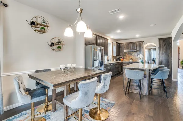 a kitchen with a table and chairs in it