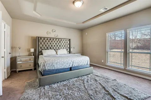 a bedroom with a large bed and a window