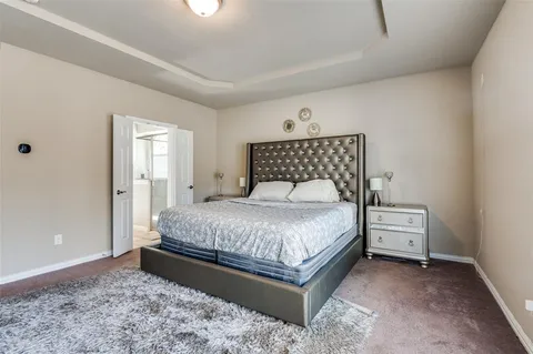 a bedroom with a bed and a view of bathroom