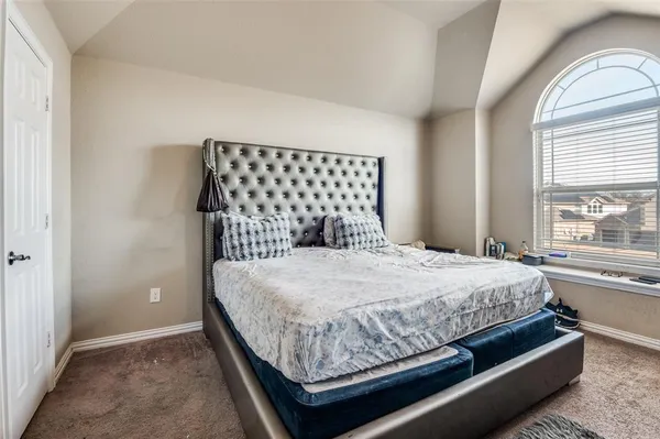 a bedroom with a bed and window