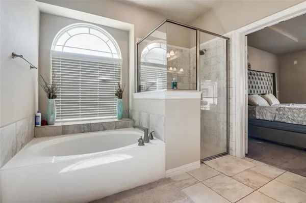 a bathroom with a tub a sink and a mirror
