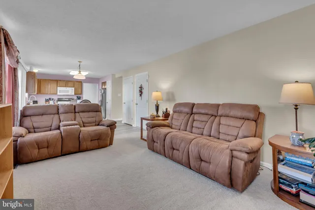 a living room with furniture and a lamp