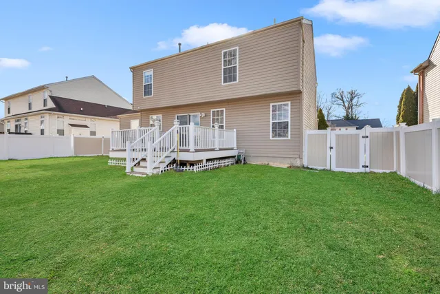 a view of a yard with large tree and wooden fence
