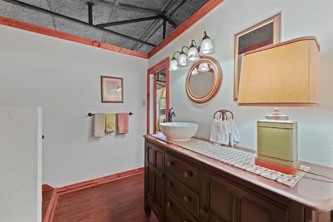 a bathroom with a granite countertop double vanity sink and a mirror