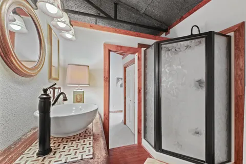 a bathroom with a sink a mirror and a shower