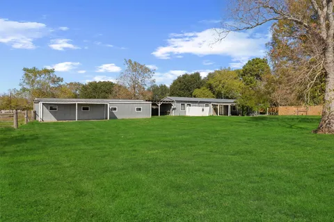 a front view of house with a garden