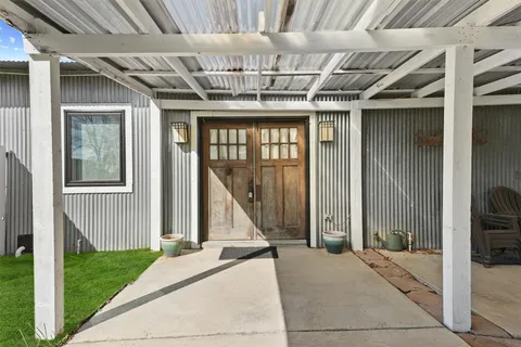 a view of a porch with a table and chairs