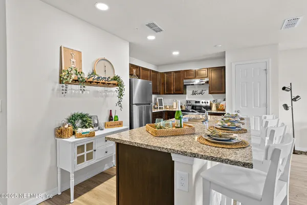 a kitchen with sink refrigerator and stove