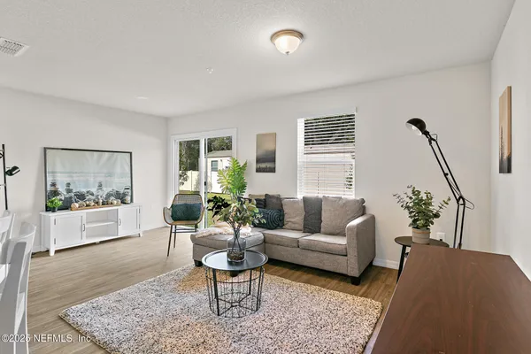 a living room with furniture and wooden floor