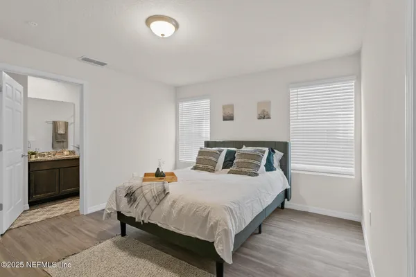 a bedroom with a bed and a couch