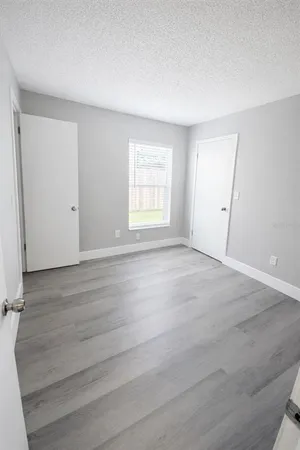 a room with a wooden floor and entryway