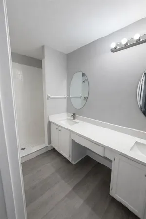 a bathroom with a sink a toilet and shower