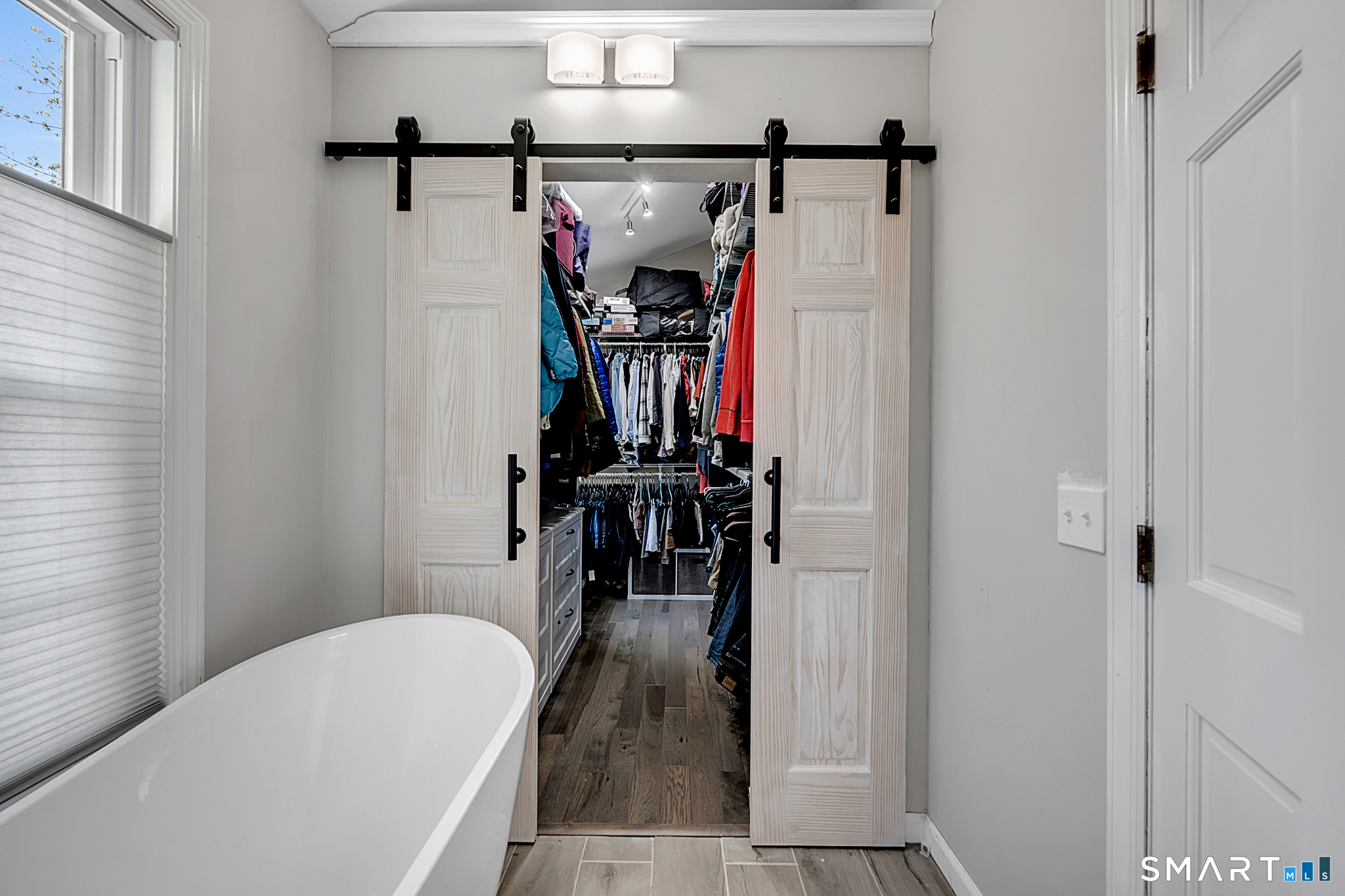 273 Osborne Hill Road Fairfield, CT 06824 - Photo 18 of 40 The custom walk-in closet for the Primary Bedroom offers plenty of storage space.