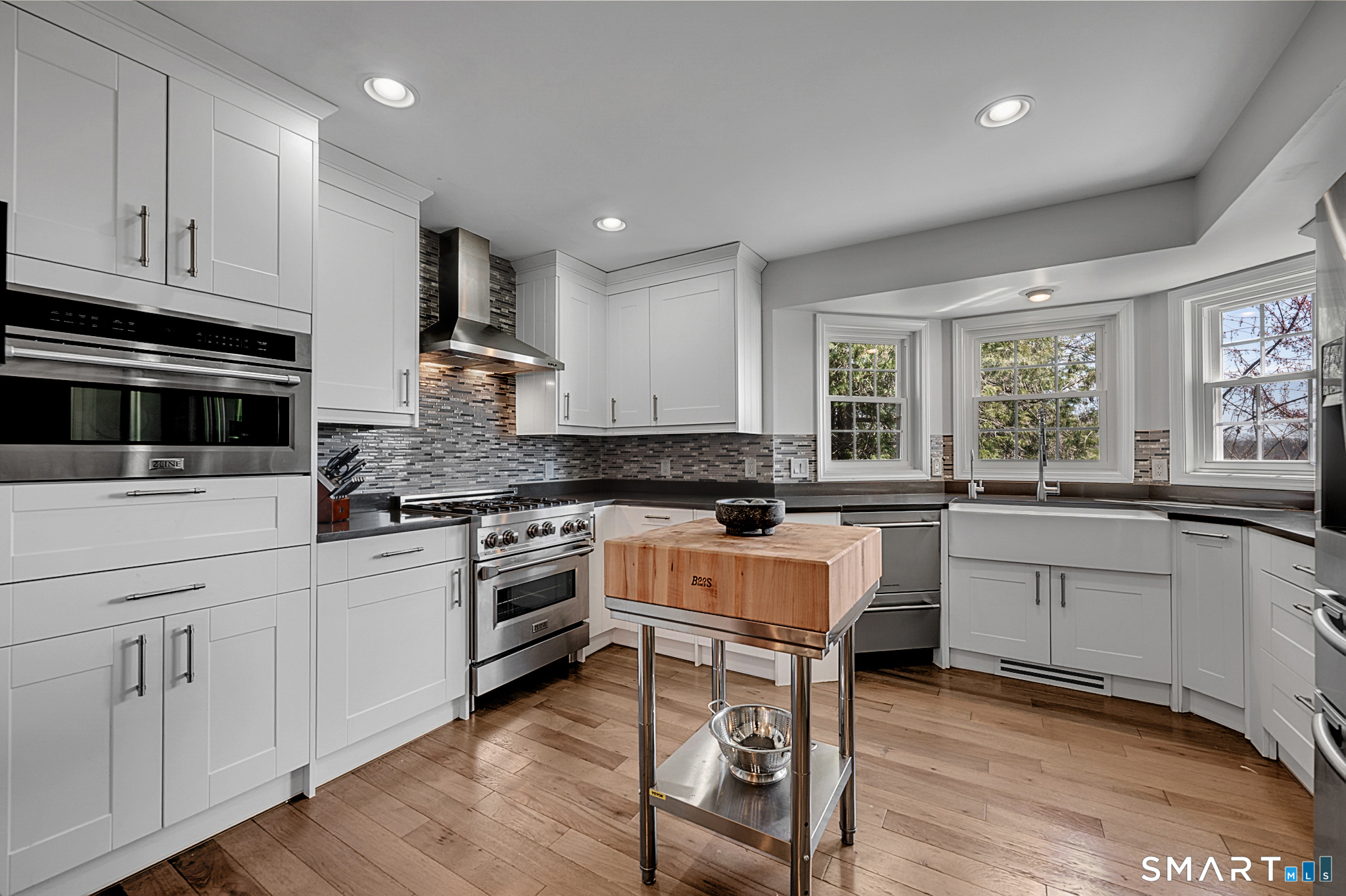 273 Osborne Hill Road Fairfield, CT 06824 - Photo 7 of 40 The Kitchen features stainless steel appliances, hardwood floors, quartz countertops and a pantry.