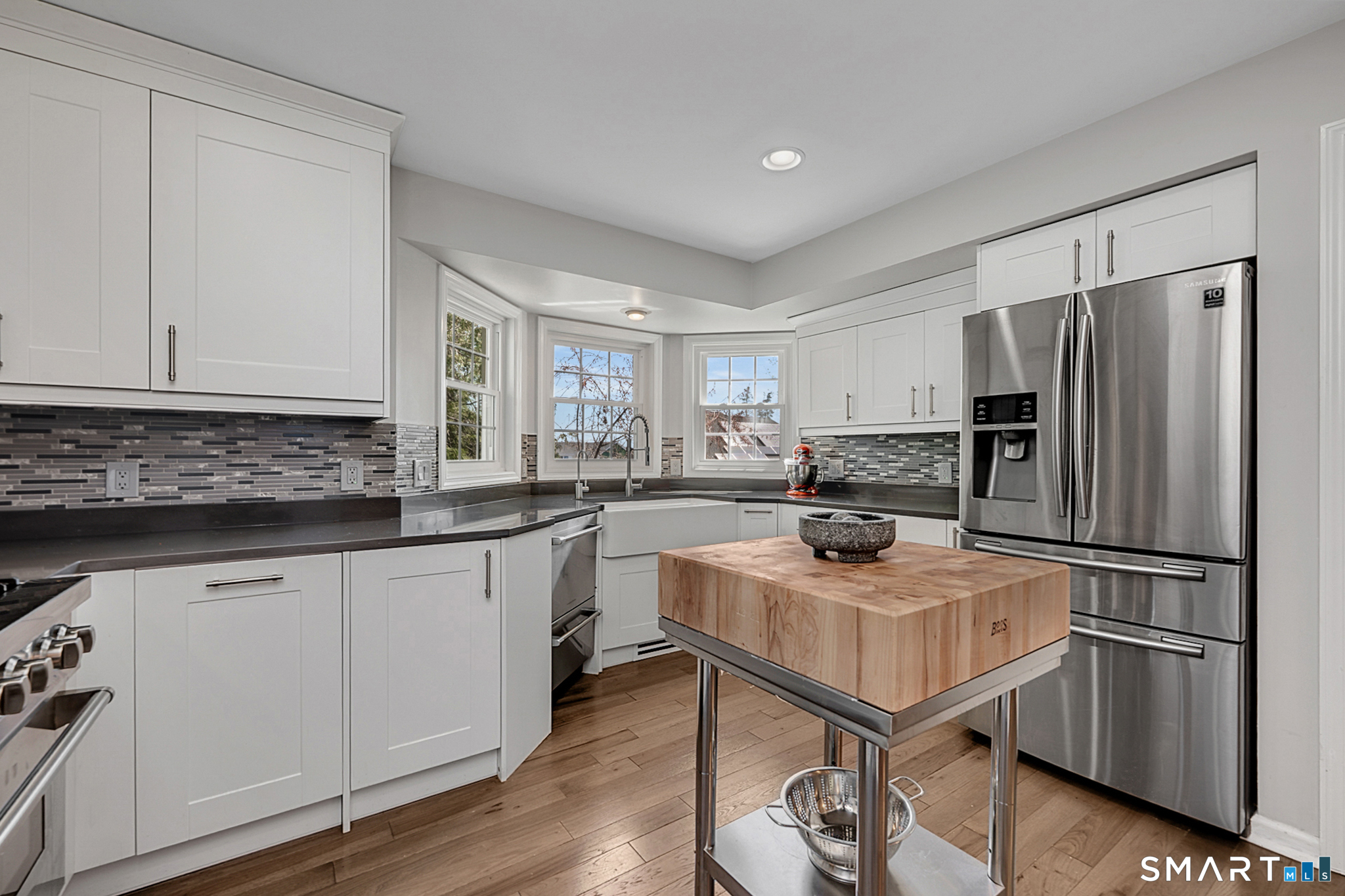 273 Osborne Hill Road Fairfield, CT 06824 - Photo 8 of 40 Light pours into the Kitchen from the three windows surrounding the sink.