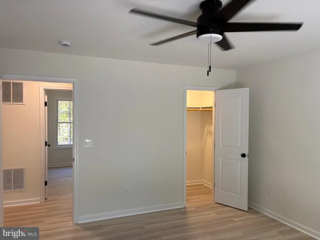 a view of hallway with wooden floor