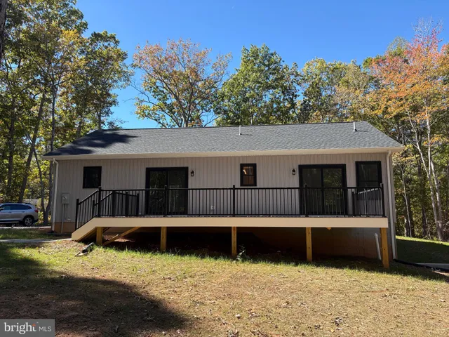 a view of a house with a yard covered in snow