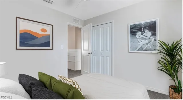 a bedroom with a bed and a painting on the wall