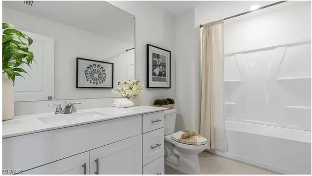 a bathroom with a toilet a sink and a large mirror
