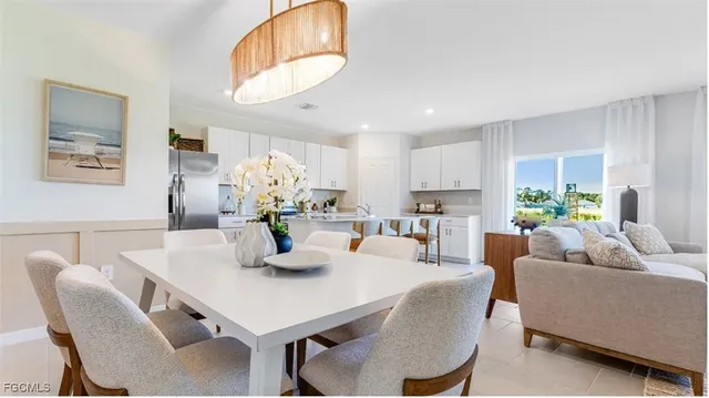 a view of a dining room with furniture and a chandelier