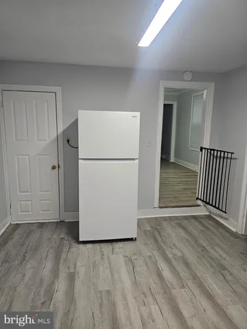 a view of a room with wooden floor and a cabinet