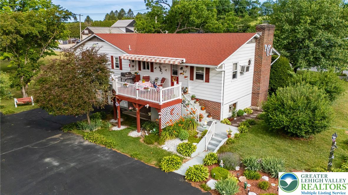 678 Interchange Road Kresgeville, PA 18333 - Photo 5 of 45 A classic facade with a welcoming porch and vibrant landscaping, offering outdoor enjoyment.