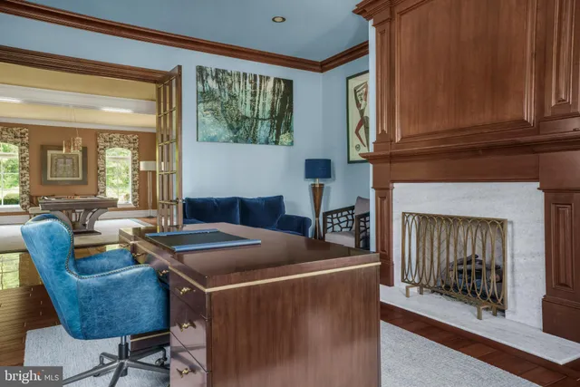 a view of a livingroom with workspace and windows