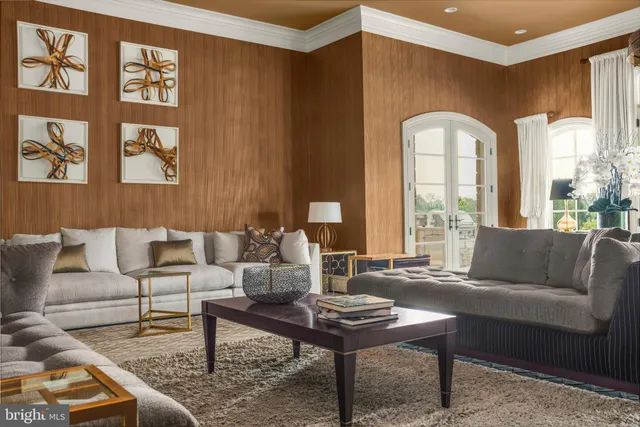 a living room with furniture and a painting on the wall