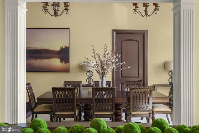 a view of a a dining room with furniture window and wooden floor